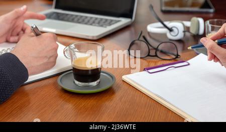 Business meeting. Two young people at the office table, man and woman working together. Teamwork, modern creative office concept, close up view Stock Photo