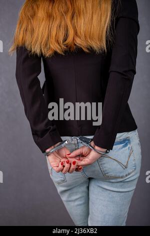 women's hands in handcuffs behind their backs Stock Photo
