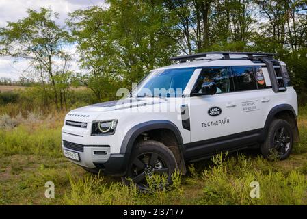 Russia, Rostovskaya oblast, 2021 June 09: Modern new SUV car Land Rover Defender, test drive in a field. Offroad 4x4 driving in wild. Stock Photo