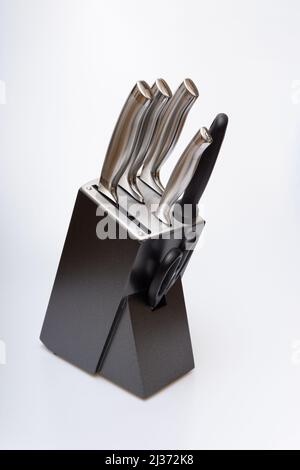 Various kitchen knives, scissors and cutting board Stock Photo