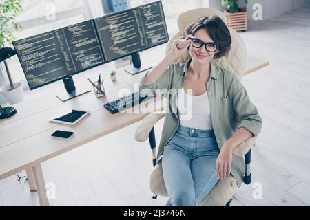 High angle view photo of confident successful web designer sitting chair hand touch spectacles office indoors Stock Photo