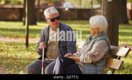 Handicapped blind people emotional support rehabilitation concept medium shot selective focus park background . High quality photo Stock Photo