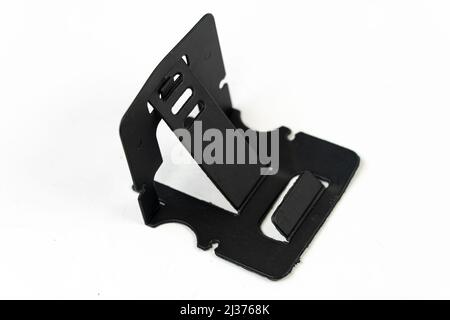 Plastic phone holder isolated on white background, black phone holder for desk, cellphone stand front view Stock Photo