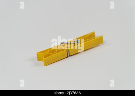 Clothes peg isolated on white background, single yellow clothes pegs, front view Stock Photo