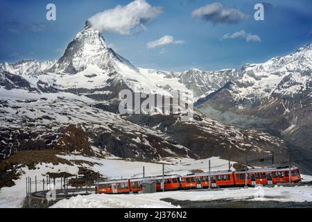 A train from Zermatt approaching the Gornergrat Station facing the majestic shape of the Matterhorn, Valais, Switzerland, Europe.  With its sunny obse Stock Photo