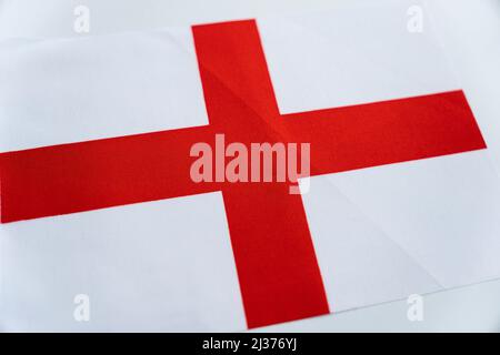 Flag of England silk. Fabric flag of England on a white table Stock Photo