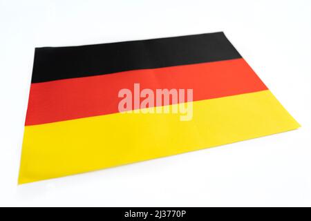 close up shot of flag of germany. Fabric flag of germany on a white table Stock Photo