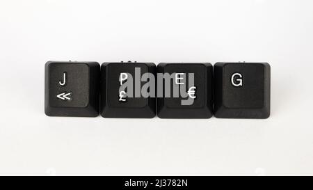 JPEG text created with keyboard keys isolated on white background, white jpeg on black keyboard, top view Stock Photo