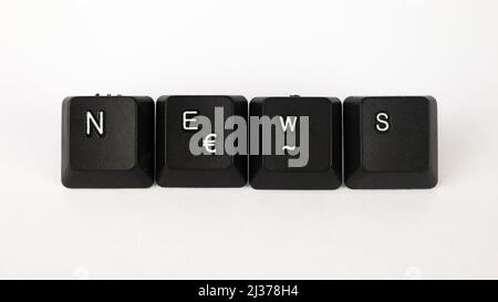 News text created with keyboard keys isolated on white background, white news on black keyboard, top view Stock Photo