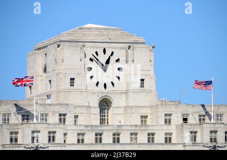 Biggest* clock face in UK Big Benzene on London landmark Shell Mex House grade ii listed office building Union jack & Stars & Stripes flags England UK Stock Photo