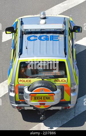 Unusual aerial roof and back view of numbers on Essex constabulary police patrol car manoeuvring through grid locked motorway traffic jam  England UK Stock Photo