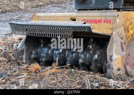 Forestry mulcher attachment for backhoe close up, land clearing heavy equipment Stock Photo