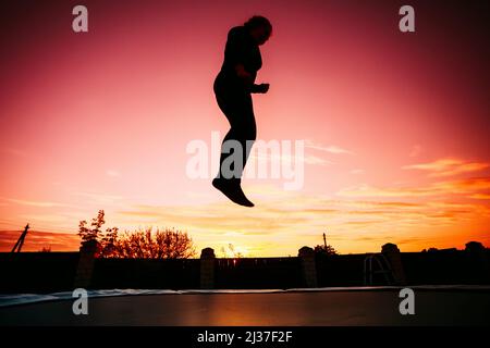 Silhouette of a young sexy nude woman with big beautiful breasts lies