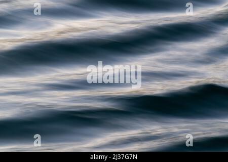 Wavy water surface in close up, abstract landscape with waves moving diagonally Stock Photo
