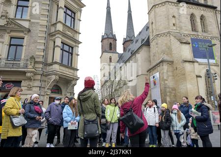 06 April 2022, Saxony-Anhalt, Halle (Saale): Guest guide Beate Krauße (r) and interpreter Roksolana Grabko (l) lead refugees from Ukraine through the city and to the Marktkirche. In addition to relevant points such as the city administration building, shopping opportunities, gastronomic and museum facilities and selected tourist points in the city center and old town area are presented. Photo: Heiko Rebsch/dpa Stock Photo