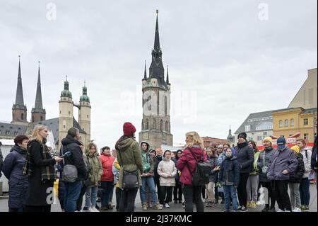 06 April 2022, Saxony-Anhalt, Halle (Saale): Guest guide Beate Krauße (r) and interpreter Roksolana Grabko (l) lead refugees from Ukraine through the city and onto the market square. In addition to relevant points such as the city administration building, shopping opportunities, gastronomic and museum facilities and selected tourist points in the city center and old town area are also presented. Photo: Heiko Rebsch/dpa Stock Photo