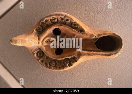 old roman terracotta lucern lamp detail Stock Photo