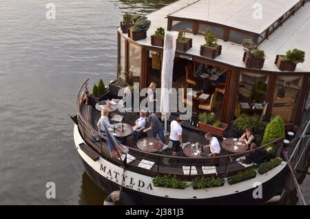 Boat Hotel Matylda restaurant, people dining on the river Vltava in Prague Czech Republic. Stock Photo