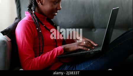 African Teen Girl Using Laptop Computer Browsing Internet Sitting On ...