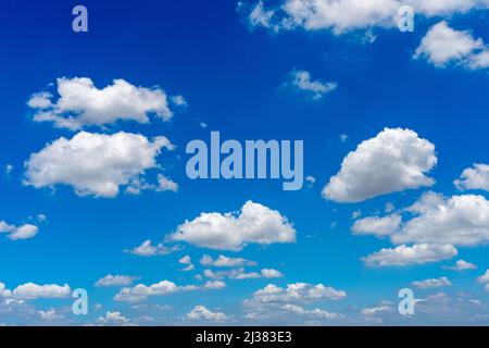 White cumulus clouds floating in the blue sky Stock Photo
