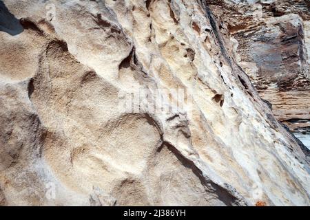 Surface sandy rock. Rocky shore of the Caspian Sea. Stock Photo