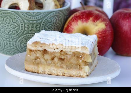 Portion of apple pie and fresh apples in the background. Party dessert Stock Photo