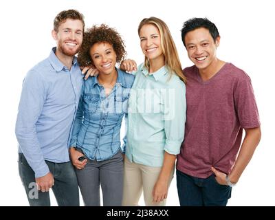 The four of us is plenty. Studio portrait of a group of friends posing together against a white background. Stock Photo