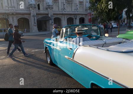 Man driving his car towards, Gran Teatro de La Habana Alicia Alonso before sunset Stock Photo