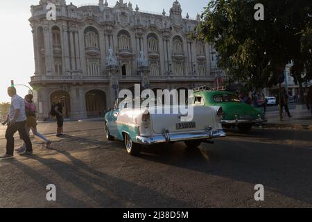 Man driving his car towards, Gran Teatro de La Habana Alicia Alonso before sunset Stock Photo