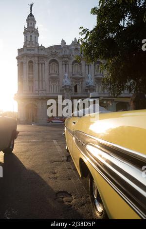 Man driving his car towards, Gran Teatro de La Habana Alicia Alonso before sunset Stock Photo