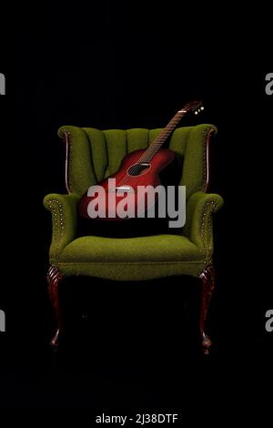 Beautiful red guitar on a green vintage arm chair Stock Photo