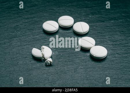 MDMA Pill known as ecstasy  E  or molly, is a psychoactive drug primarily used for recreational purposes. MDMA drugs  on black background Stock Photo