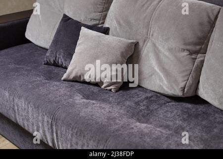blue and grey pillows on couch in living room Stock Photo