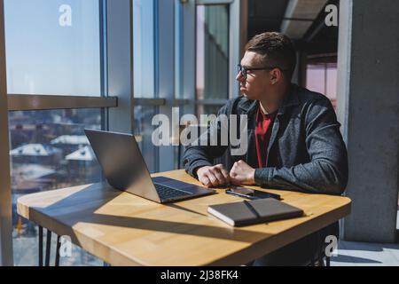 Professional manager working with business information, corporate money investment report, writing notes while doing online research on laptop compute Stock Photo