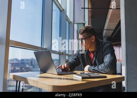 Professional manager working with business information, corporate money investment report, writing notes while doing online research on laptop compute Stock Photo