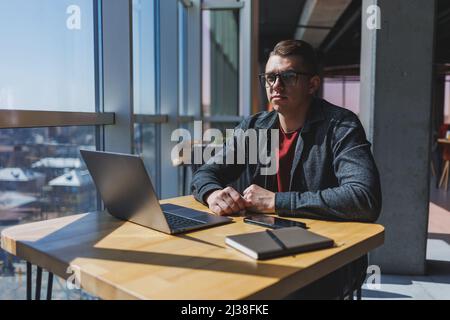 Professional manager working with business information, corporate money investment report, writing notes while doing online research on laptop compute Stock Photo