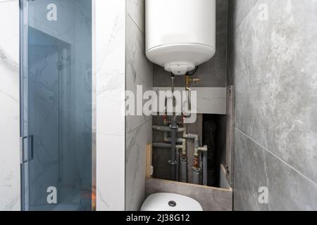 Installation and setting the new gas boiler for hot water and heating. Technician servicing the house heating system. Stock Photo