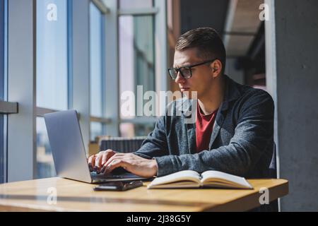 Professional manager working with business information, corporate money investment report, writing notes while doing online research on laptop compute Stock Photo