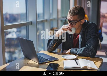 Professional manager working with business information, corporate money investment report, writing notes while doing online research on laptop compute Stock Photo
