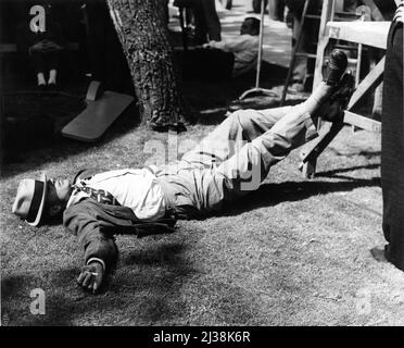 GARY COOPER relaxing / sleeping on set during location filming of MEET JOHN DOE 1941 director FRANK CAPRA based on story by Richard Connell and Robert Presnell screenplay Robert Riskin Frank Capra Productions / Warner Bros. Stock Photo