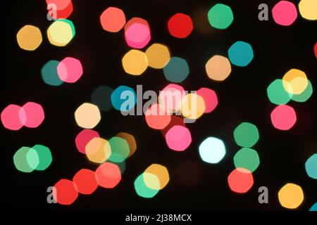 Defocused colorful lights on black background Stock Photo