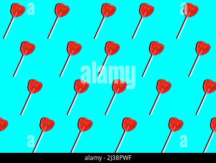Heart-shaped lollipops pattern on turquoise blue background. Pop art lollipop. Stock Photo