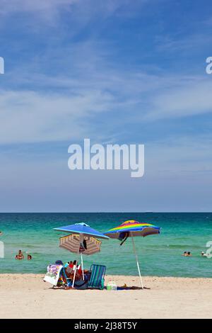 MIAMI, USA - JULY 31, 2010: umbrellas at the beautiful beach for sun protection Stock Photo