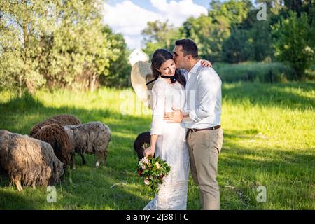 Full length body portrait of young bride and groom enjoying romantic moments outside at sunset in beautiful summer day. Wedding couple. Standing face