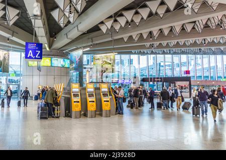 FRANKFURT, GERMANY - MAY 18, 2017: people Inside of Frankfurt international Airport in the departure hall. Frankfurt Airport is a major international Stock Photo