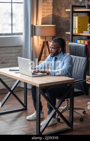 Focused businessman typing on the notebook computer Stock Photo