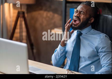 Young office worker having a severe toothache Stock Photo