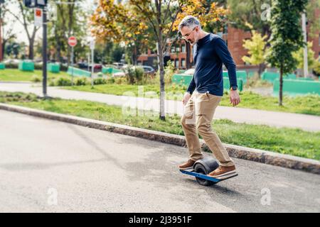 man with electric transporter riding in the street Stock Photo