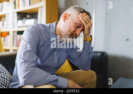 40s or 50s sad and worried man with grey hair Stock Photo