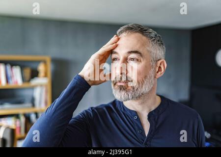 40s or 50s sad and worried man with grey hair Stock Photo